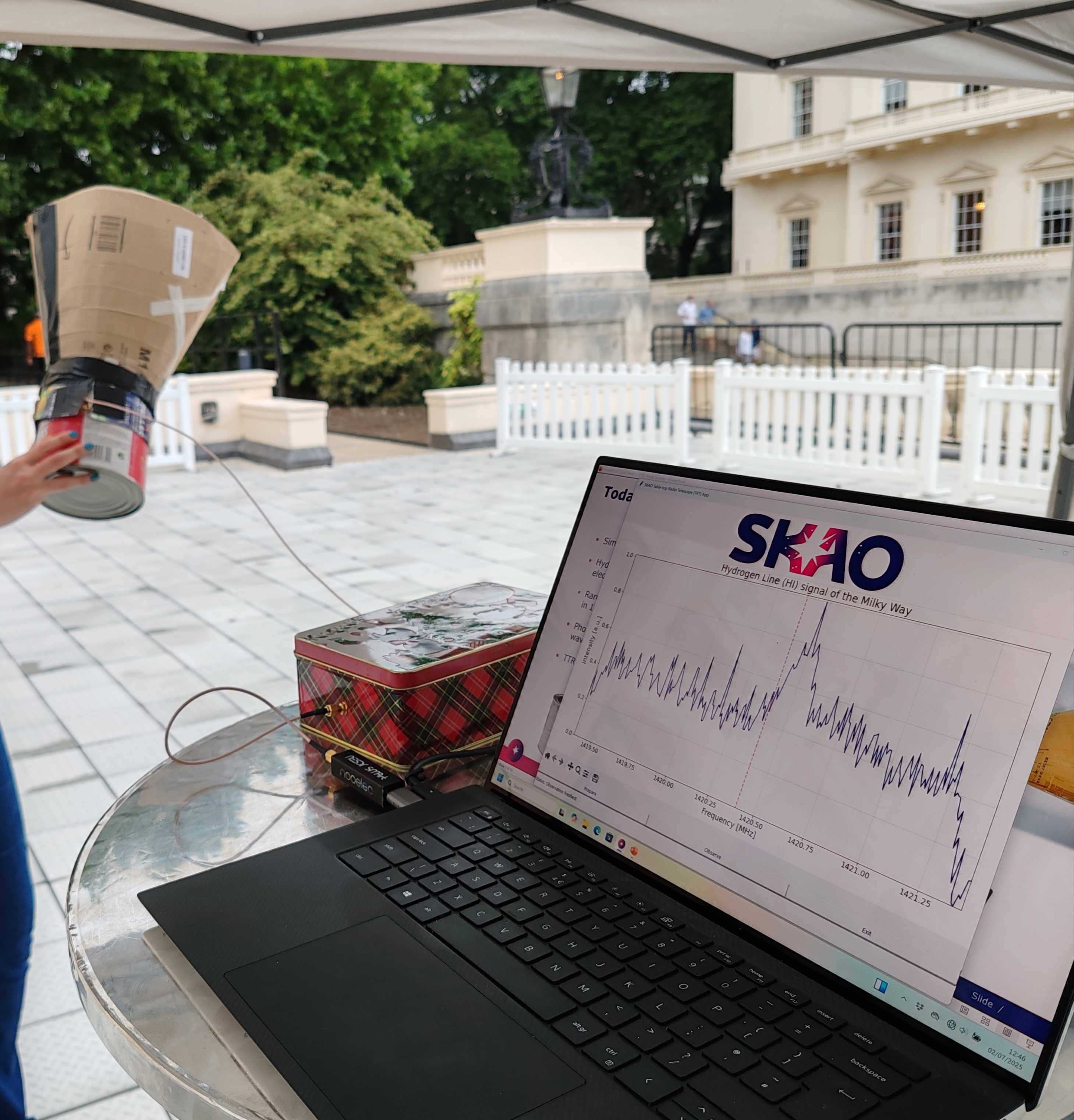 A tabletop radio telescope. A "dish" made of cardboard and a paint can, hooked up to a laptop.